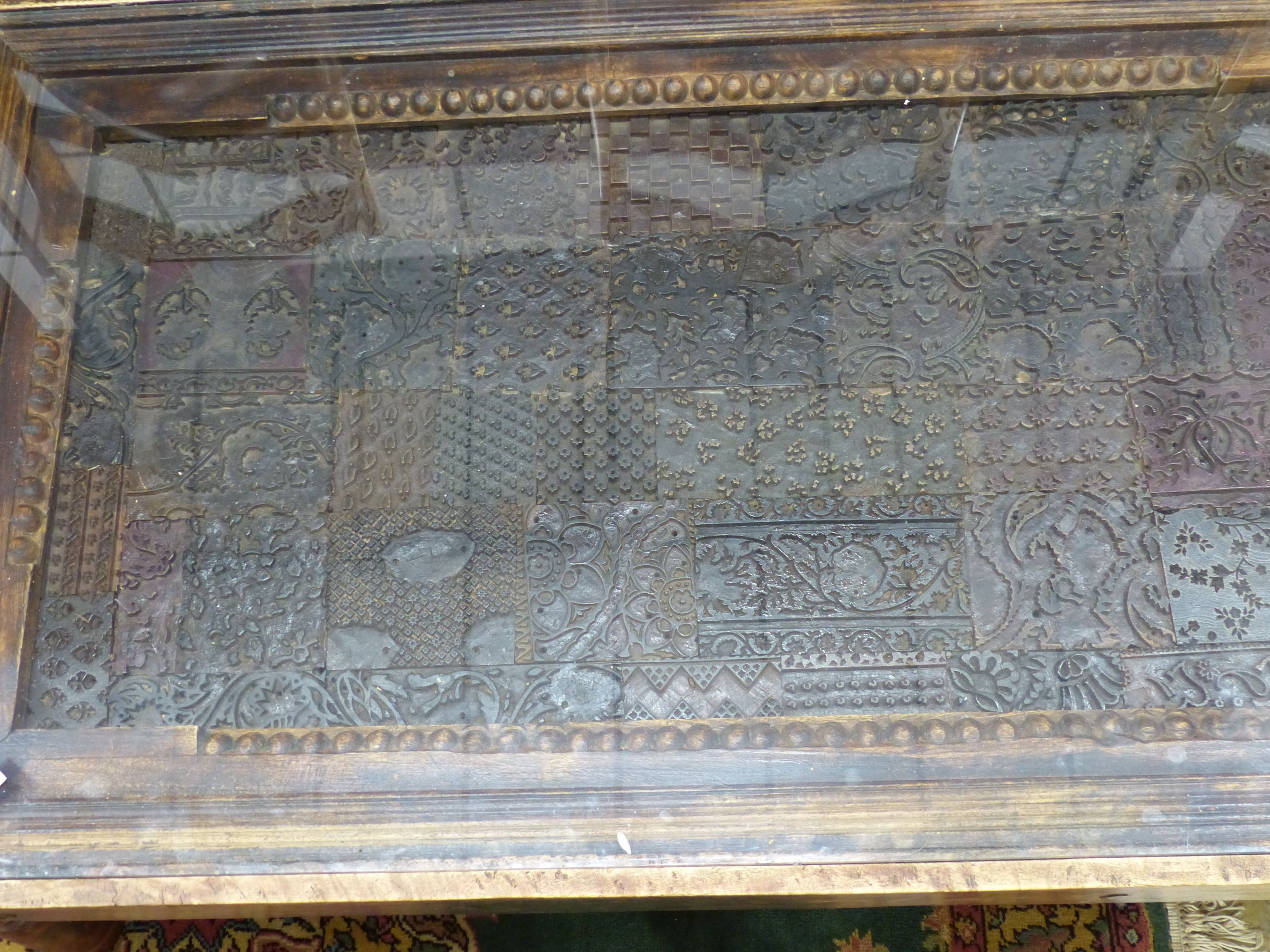 An Indian hardwood coffee table inset with a printing block, length 140cm, width 80cm